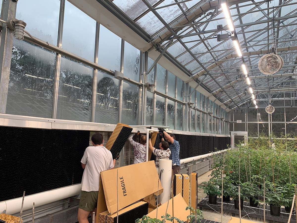 Setting evaporative cooling pads at the three greenhouse sites at the University of Georgia in Athens,